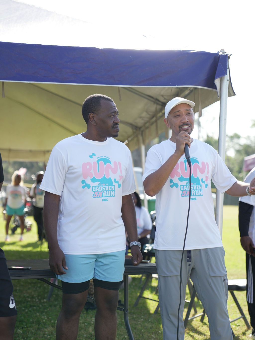 The founders addressing participants on the microphone at the inaugural 2025 Gadsden 5K Run